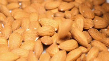Super slow motion of an almond falling on a brown background at 240 fps.