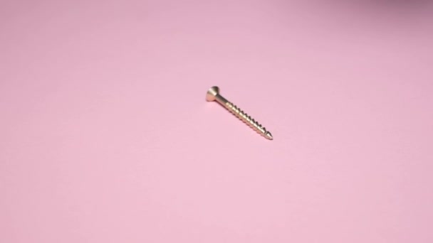 Macro Shot Metal Bolts Pink Background Super Slow — Stock Video