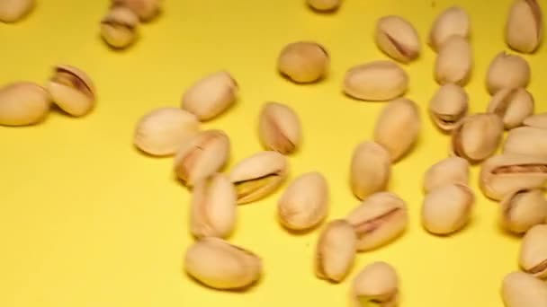 Pistachio Nuts Yellow Background Close Slow Motion — стоковое видео