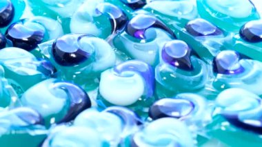 Powder and liquid blue washing machine detergent. macro Rotation. 4k video