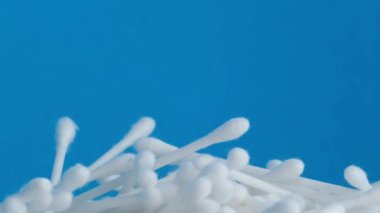 Cosmetic cotton buds, close-up, on a blue background. 4k video