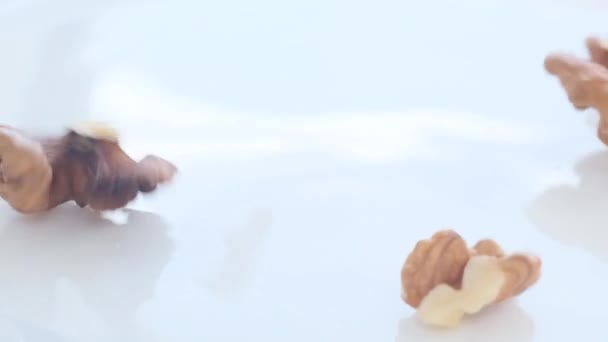 Close Falling Walnuts White Background Healthy Vegan Food Macro Video — стоковое видео