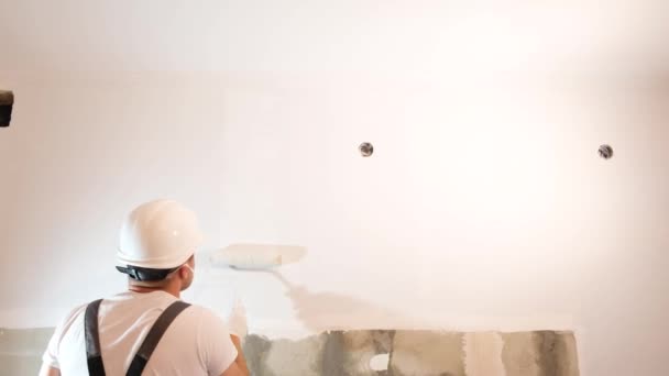 Young Male Decorator Paints Wall Empty Room Concept Builder Artist — Video Stock