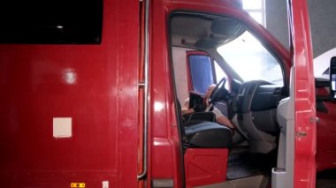 A car mechanic carries out computer diagnostics of a truck. Truck at the service station, maintenance.