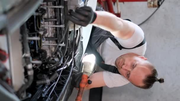 Vertical Video Professional Car Mechanic Repairs Car Engine Modern Car — стоковое видео