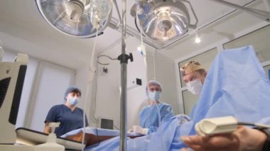 The team of doctors during the operation in medical office. Surgical intervention. Operative intervention