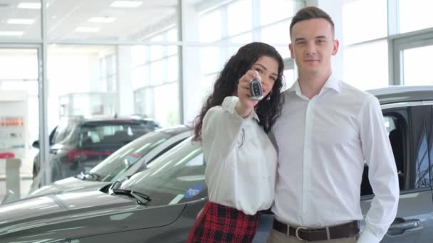 Happy Young Couple Bought New Car Car Dealership Woman Shows — стокове відео