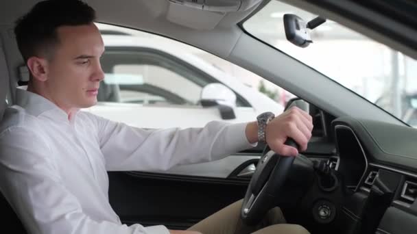 Young Business Man Stroking Steering Wheel Electric Car Buying New — Vídeo de stock