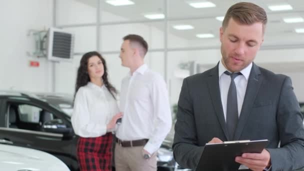 Portrait Male Car Sales Manager Background Customers Choose Car — Video Stock