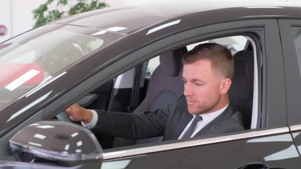 Portrait Man Driving New Luxury Car Examines Interior Car Buyer — Stock video