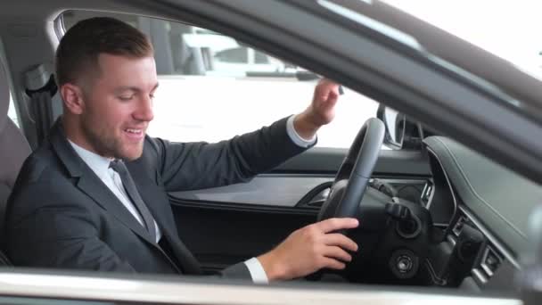 Portrait European Man Driving New Luxury Electric Car Car Showroom — стоковое видео