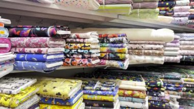 Store of textile colored fabric. Fabrics of different colors from different materials. Textile shop.