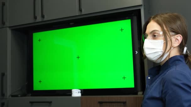 若い女性医師 緑のクロマキー画面の背景にマスクの看護師 医療における近代技術 医学発表 — ストック動画