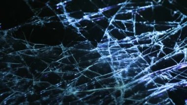 Macro video of cracked smartphone glass illuminated by LED light. Cracks in the glass.