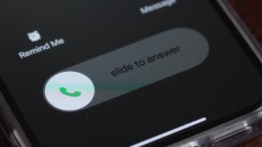 Macro video of an incoming call on a mobile phone. Pick up or reject a call on your smartphone.