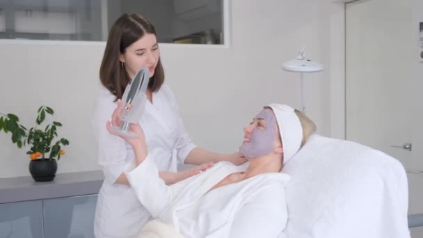 Woman Spa Rejuvenating Facial Treatment Beautician Put Mask Clients Face — Video