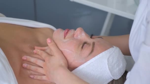 Relaxed Woman Lying Sofa Luxury Beauty Salon Rejuvenating Facial Massage — стоковое видео