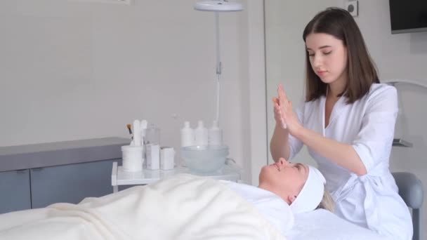 Relaxed Woman Lying Sofa Luxury Beauty Salon Rejuvenating Facial Massage — Video Stock