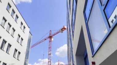 Construction crane on a construction site against a blue sky. Construction concept.