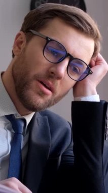 The manager falls asleep at the workplace in the office, he is tired from hard work at the computer. Vertical video