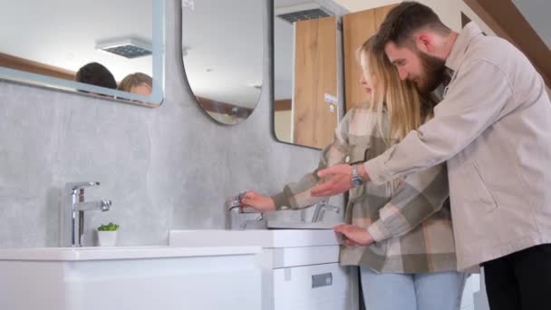 配管と家具部門の若いカップル 夫と妻は新しいバスルームのための家具を選択します 新しい家を修理 バスルームインテリアデザイン — ストック動画
