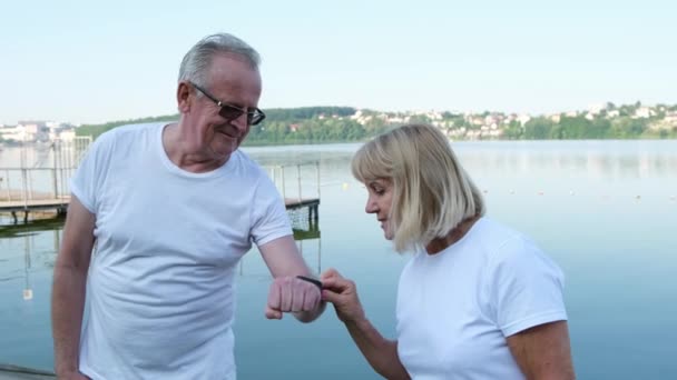 Senior Couple Exercising Outdoors Using Smart Watch Concept Healthy Sports — Stock Video