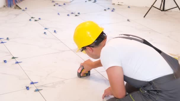 将瓷砖铺在混凝土地板上的施工维修 修理工用刷子擦地板 垂直录像 — 图库视频影像