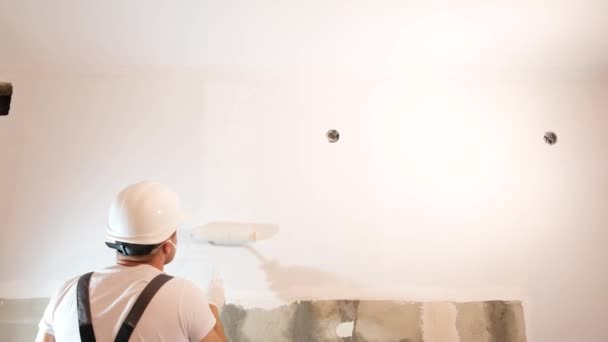 Young Male Decorator Paints Wall Empty Room Concept Builder Artist — Αρχείο Βίντεο