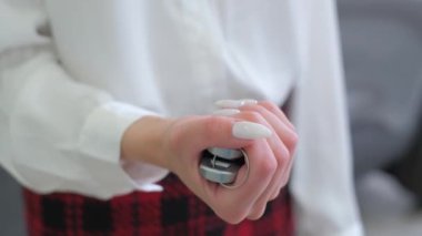 A woman shows the keys to a new car, she bought a new car at a car dealership. Close up