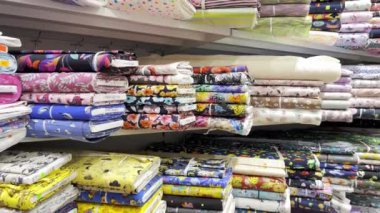 Store of textile colored fabric. Fabrics of different colors from different materials. Textile shop.