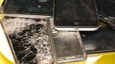 Outdated models of mobile phones and smartphones. Electronic waste concept. Video rotation. 