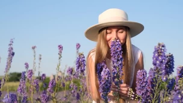 Close Portrait Woman White Hat Enjoying Aroma Blue Wildflowers Beautiful — Stock Video