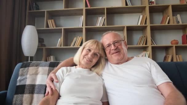 Loving Elderly Man Glasses Hugging Smiling Wife Looking Camera Gray — Stock Video