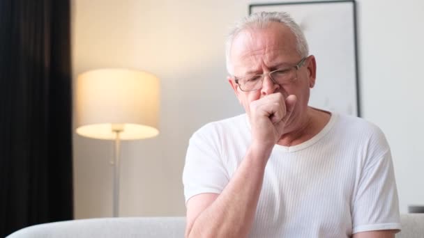 Sick Elderly Grandfather Coughs While Sitting Sofa Apartment Heating Due — ストック動画