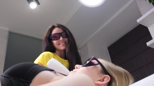 Positive Smiling Beautician Epilates Young Womans Face Protective Glasses Laser — ストック動画