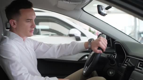 Young Business Man Stroking Steering Wheel Electric Car Buying New — Wideo stockowe