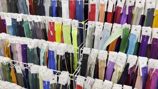 Many Different Zippers Clothes Different Sizes Colors Lightnings Placed Racks — 图库视频影像