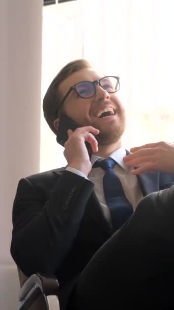 Happy Businessman Workplace Has Put His Feet Table Talking Smartphone — Vídeo de stock