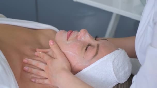 Relaxed Woman Lying Sofa Luxury Beauty Salon Rejuvenating Facial Massage — Video Stock