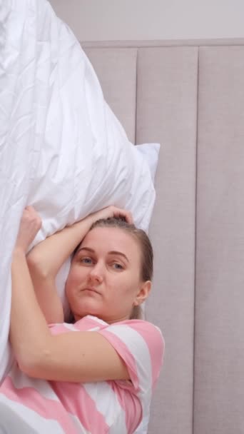 悲しい女性はベッドに横たわり 不眠症に苦しんでいる バーティカルビデオ — ストック動画
