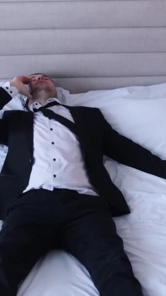 Tired Relaxed Man Black Business Suit Lying Large White Bed — Stock Video