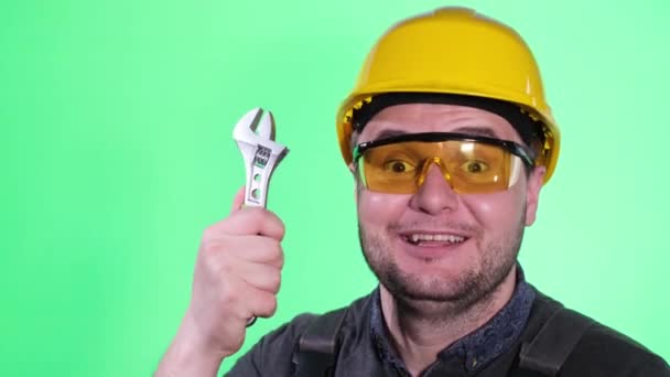 Qualified Plumber Uniform Showing Wrench While Looking Camera Green Background — Stock Video