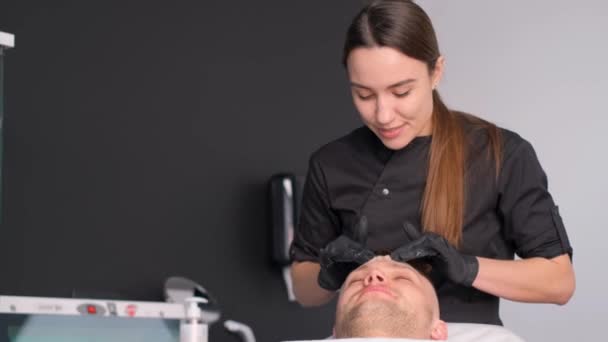 European Man Lying Spa Bed Receiving Facial Skin Massage Aromatic — Stock Video