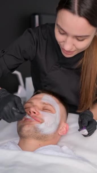 Vertical Video Man Spa Getting Facial Cosmetologist Performs Facial Massage — Stock Video