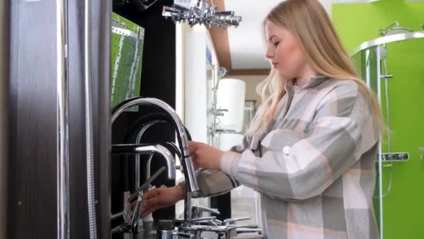 Een Vrouw Onderzoekt Het Assortiment Een Loodgieterij Sanitair Kopen Een — Stockvideo