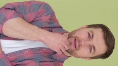 Stüdyoda izole edilmiş Amerikalı dalgın bir adamın portresi. Dikey video.