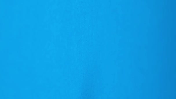 金属螺栓以慢动作落在蓝色背景上 广告建设的概念 垂直录像 — 图库视频影像