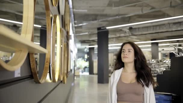 Eine Frau Wählt Einen Spiegel Für Die Wohnung Einem Geschäft — Stockvideo