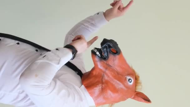 Man Horse Mask Dances Looking Camera Vertical Video — Stock Video