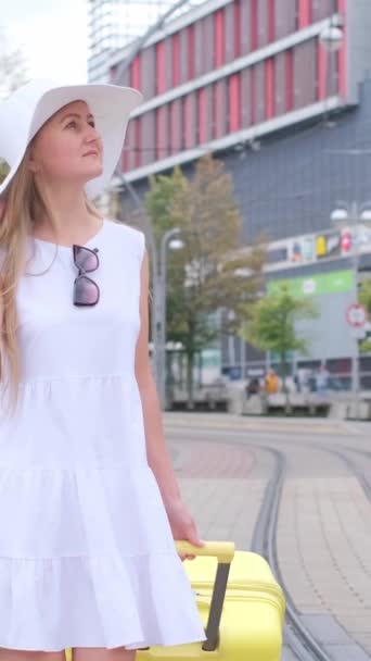 Woman White Hat Suitcase Walks City Tram Tracks Vertical Video — Stock Video